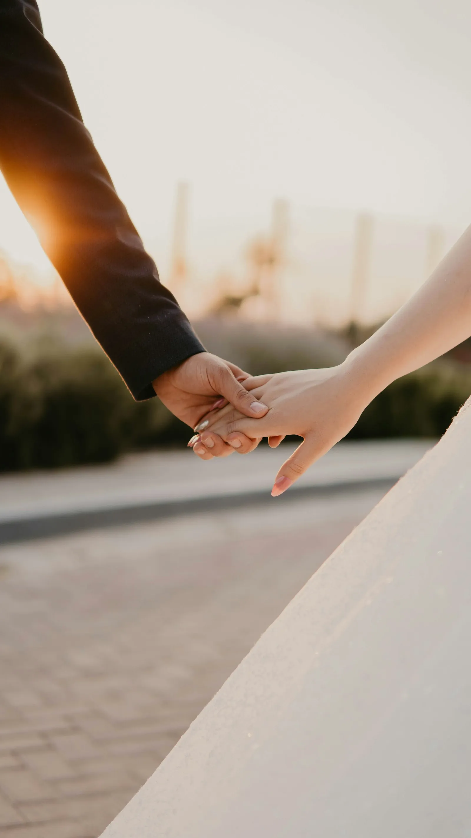 A couple holding hands in warm evening backlight
