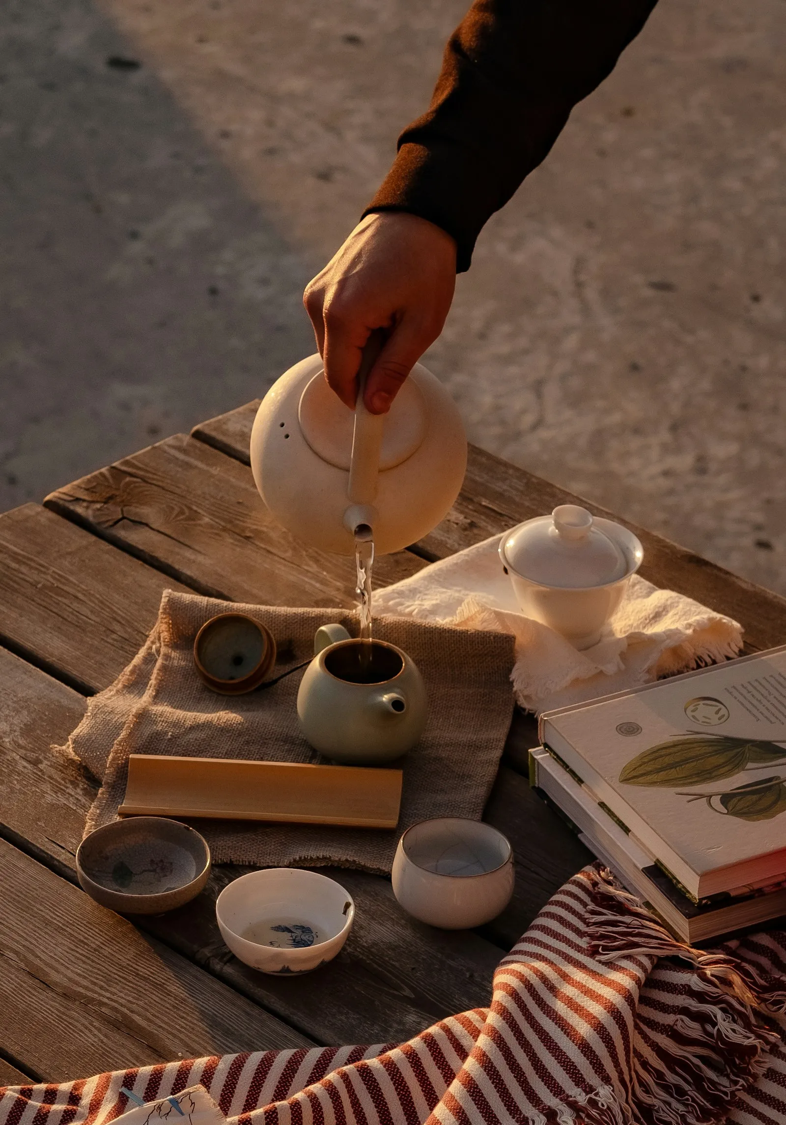 Pouring tea at a wooden table